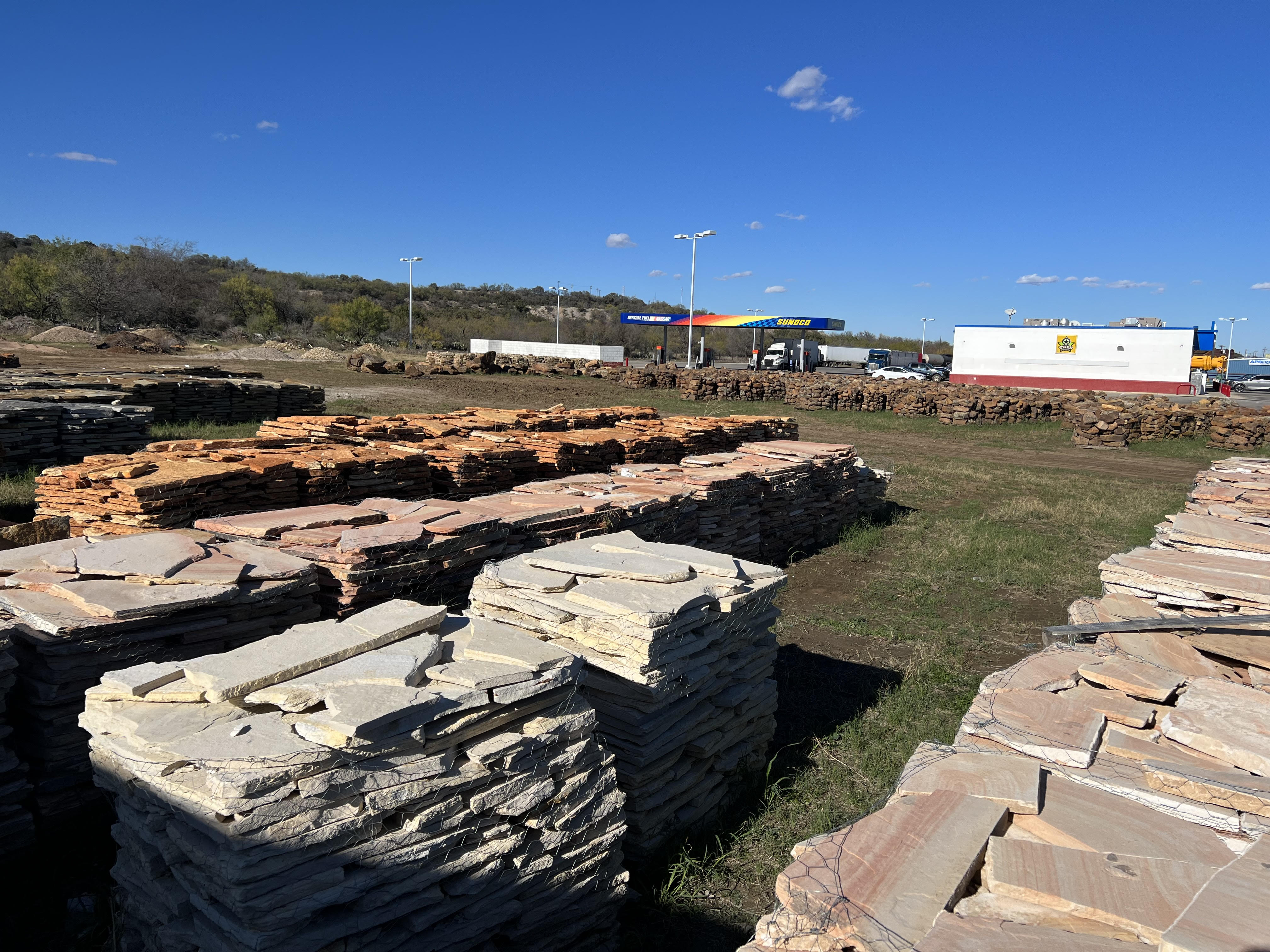 Pallets of flagstone and patio stone stacked at the Trees Forever Nursery rock yard in Brownwood, TX